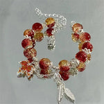 Armband mit silbernem Herbstblatt und Schmetterling
