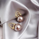 Fette Ohrringe mit Margeriten in Gold – Braun