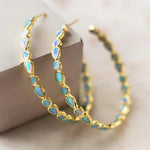 Retro goldene Ohrringe mit blauem Opal