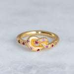 Retro rosa Ring mit goldenem Himmelknoten